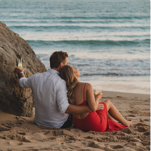 A couple relaxing on a beach at sunset, sharing an intimate moment that reflects connection and Mutual Climax