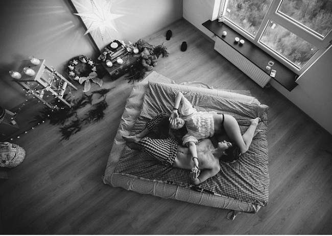 Two people lie on a mattress, sharing intimacy through mutual climax.